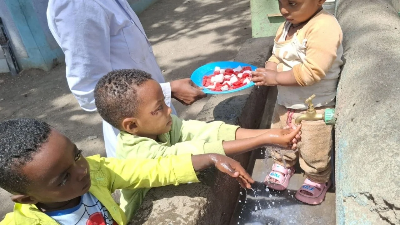Children in the Day-care center washing their hands with soap before their lunch